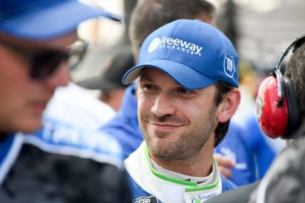 NASCAR Cup Series driver Daniel Suarez (99) smiles after securing pole position Saturday, Aug. 12, 2023, during qualifying for the NASCAR Cup Series Verizon 200 at Indianapolis Motor Speedway.