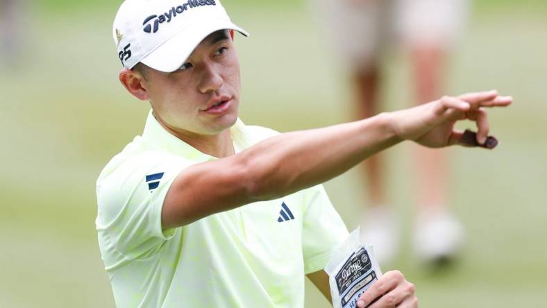 PGA Tour player Collin Morikawa points down the fairway after teeing off on the first hole during the third round of the FedEx St. Jude Championship at TPC Southwind in Memphis, Tenn., on Saturday, August 12, 2023.