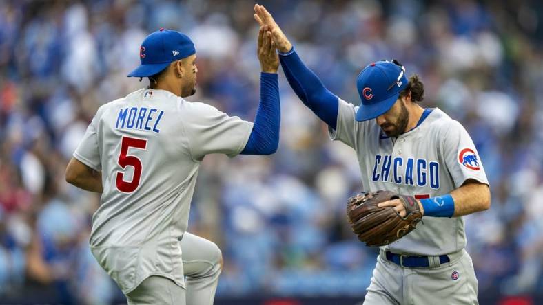 Aug 12, 2023; Toronto, Ontario, CAN; Chicago Cubs second baseman Christopher Morel (5) celebrates with teammate shortstop Dansby Swanson (7) after defeating the Toronto Blue Jays at Rogers Centre. Mandatory Credit: Kevin Sousa-USA TODAY Sports