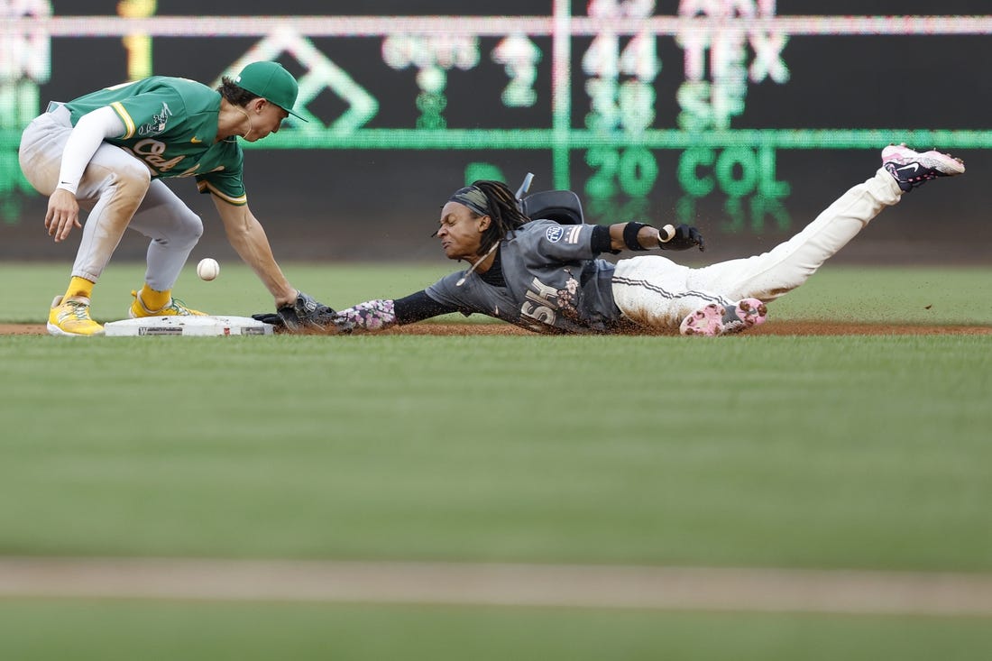 Aug 12, 2023; Washington, District of Columbia, USA; Washington Nationals shortstop CJ Abrams (5) steals second base ahead of an attempted tag by Oakland Athletics second baseman Zack Gelof (20) during the first inning at Nationals Park. Mandatory Credit: Geoff Burke-USA TODAY Sports