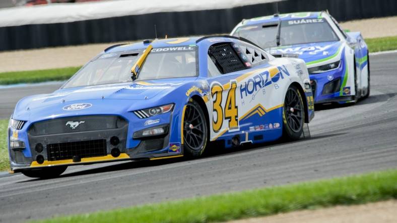 NASCAR Cup Series driver Michael McDowell (34) leads NASCAR Cup Series driver Chase Elliott (9) around the track Sunday, Aug. 13, 2023, before winning the Verizon 200 at the Brickyard at Indianapolis Motor Speedway.