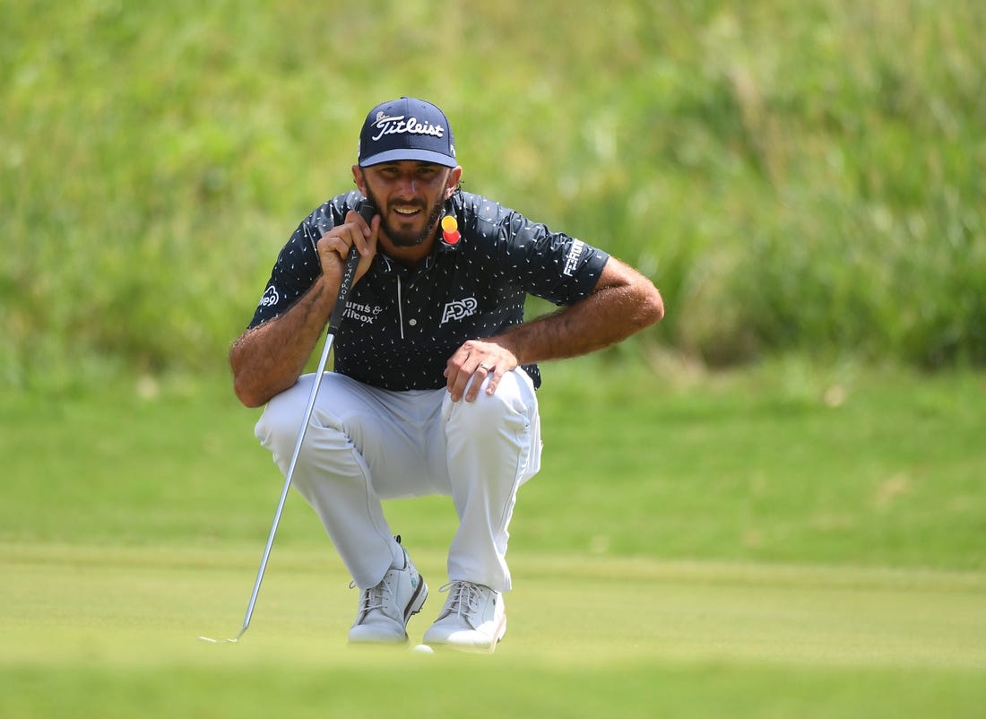 Aug 13, 2023; Memphis, Tennessee, USA; Max Homa lines up a putt on the first hole during the final round of the FedEx St. Jude Championship golf tournament. Mandatory Credit: Christopher Hanewinckel-USA TODAY Sports