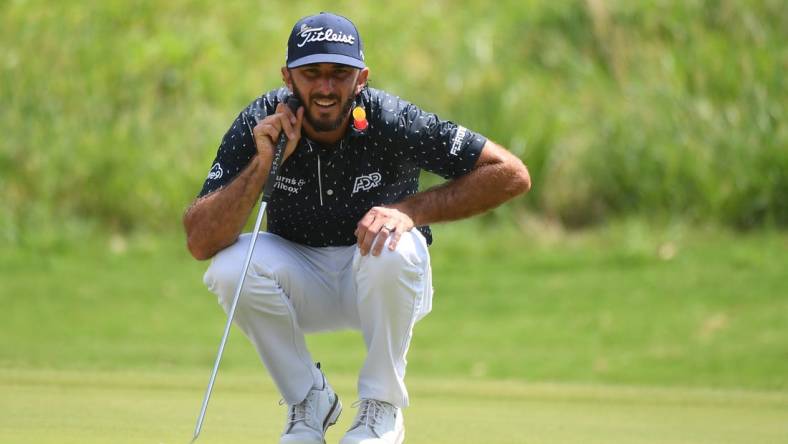 Aug 13, 2023; Memphis, Tennessee, USA; Max Homa lines up a putt on the first hole during the final round of the FedEx St. Jude Championship golf tournament. Mandatory Credit: Christopher Hanewinckel-USA TODAY Sports