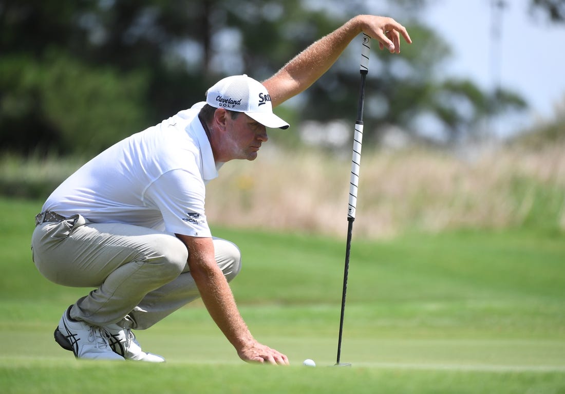 Aug 13, 2023; Memphis, Tennessee, USA; Lucas Glover works with his caddie to line up a putt during the final round of the FedEx St. Jude Championship golf tournament. Mandatory Credit: Christopher Hanewinckel-USA TODAY Sports