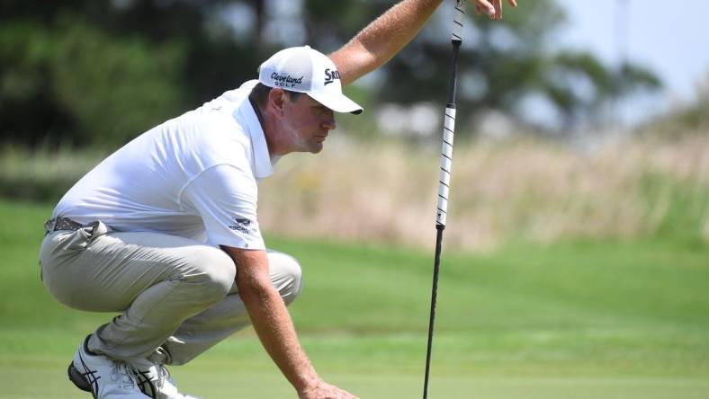 Aug 13, 2023; Memphis, Tennessee, USA; Lucas Glover works with his caddie to line up a putt during the final round of the FedEx St. Jude Championship golf tournament. Mandatory Credit: Christopher Hanewinckel-USA TODAY Sports