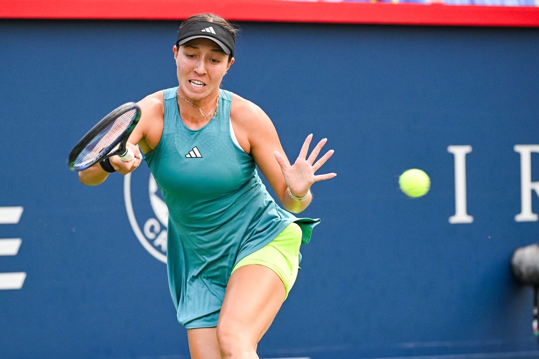 Aug 13, 2023; Montreal, Quebec, Canada; Jessica Pegula (USA) returns the ball against Liudmila Samsonova (not pictured) during singles final play at IGA Stadium. Mandatory Credit: David Kirouac-USA TODAY Sports