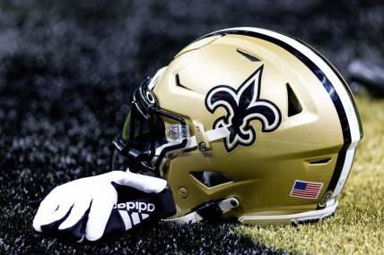 Aug 13, 2023; New Orleans, Louisiana, USA;  Detailed view of the New Orleans Saints helmet and glove during pregame against the Kansas City Chiefs at the Caesars Superdome. Mandatory Credit: Stephen Lew-USA TODAY Sports