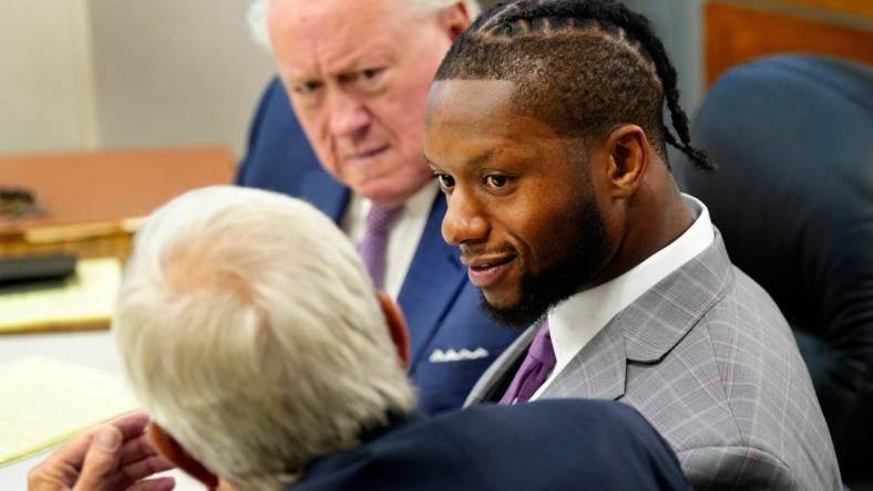 Cincinnati Bengals running back Joe Mixon confers with his attorney   s, Scott Croswell, center, and Meryln Shiverdecker, during day two of his aggravated menacing bench trial, Tuesday, August 15, 2023. Hamilton County Municipal Judge Gwen Bender is presiding over what prosecutors say was a road-rage incident involving a gun on Jan. 21, 2023 in downtown Cincinnati.