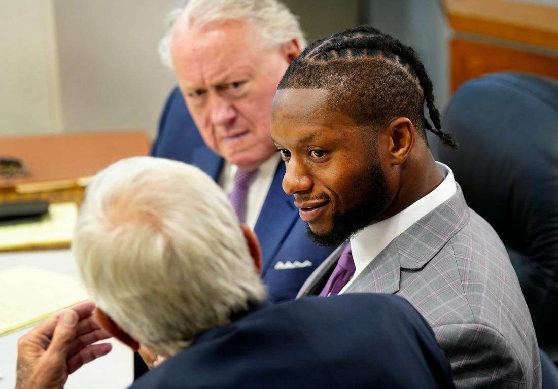 Cincinnati Bengals running back Joe Mixon confers with his attorney   s, Scott Croswell, center, and Meryln Shiverdecker, during day two of his aggravated menacing bench trial, Tuesday, August 15, 2023. Hamilton County Municipal Judge Gwen Bender is presiding over what prosecutors say was a road-rage incident involving a gun on Jan. 21, 2023 in downtown Cincinnati.