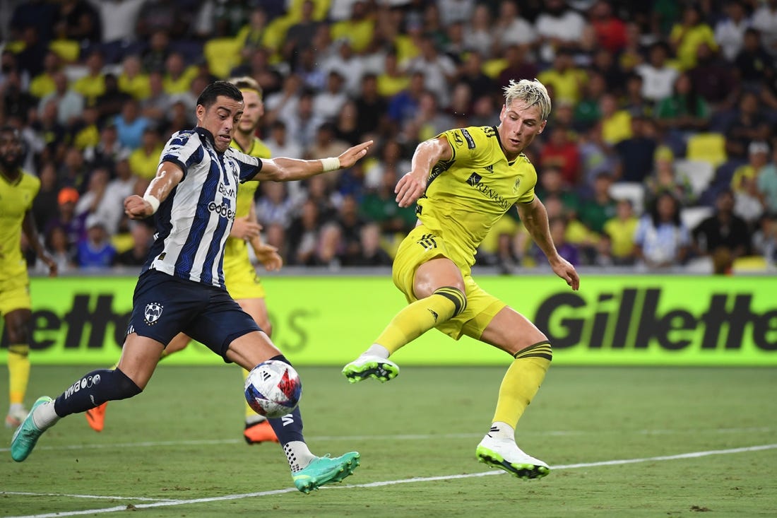 Aug 15, 2023; Nashville, TN, USA; CF Monterrey forward Rogelio Funes Mori (7) plays the ball defined by Nashville SC defender Lukas MacNaughton (3) in the first half at GEODIS Park. Mandatory Credit: Christopher Hanewinckel-USA TODAY Sports