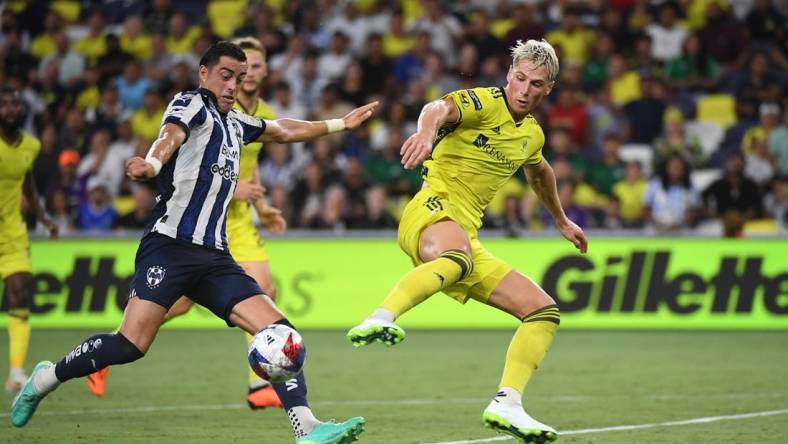 Aug 15, 2023; Nashville, TN, USA; CF Monterrey forward Rogelio Funes Mori (7) plays the ball defined by Nashville SC defender Lukas MacNaughton (3) in the first half at GEODIS Park. Mandatory Credit: Christopher Hanewinckel-USA TODAY Sports