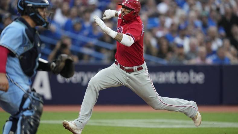 Aug 16, 2023; Toronto, Ontario, CAN; Philadelphia Phillies right fielder Nick Castellanos (8) scores against the Toronto Blue Jays on a sacrifice fly by Philadelphia Phillies left fielder Jake Cave (not pictured) during the second inning at Rogers Centre. Mandatory Credit: John E. Sokolowski-USA TODAY Sports