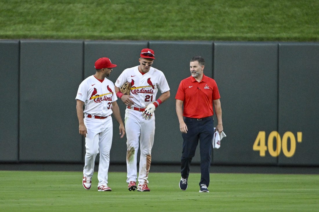 Aug 16, 2023; St. Louis, Missouri, USA;  St. Louis Cardinals center fielder Lars Nootbaar (21) walks off the field with manager Oliver Marmol (37) and a trainer after an injury during the sixth inning against the Oakland Athletics at Busch Stadium. Mandatory Credit: Jeff Curry-USA TODAY Sports