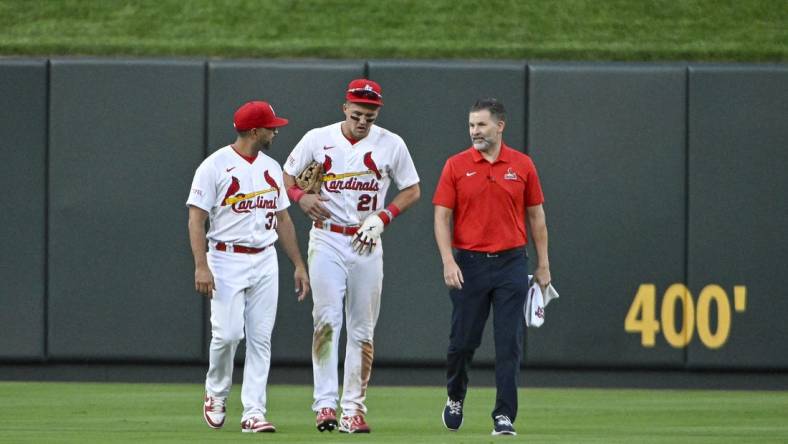 Aug 16, 2023; St. Louis, Missouri, USA;  St. Louis Cardinals center fielder Lars Nootbaar (21) walks off the field with manager Oliver Marmol (37) and a trainer after an injury during the sixth inning against the Oakland Athletics at Busch Stadium. Mandatory Credit: Jeff Curry-USA TODAY Sports