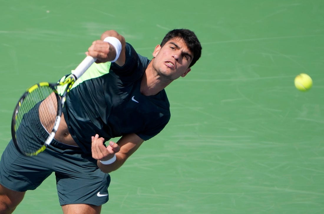 The number one ranked Carlos Alcaraz of Spain, makes a shot to Tommy Paul (14) of the United States on Center Court during the 3rd round of the Western & Southern Open at the Lindner Family Tennis Center in Mason Thursday, August, 17, 2023.