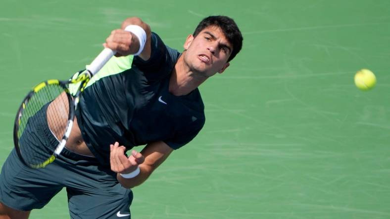 The number one ranked Carlos Alcaraz of Spain, makes a shot to Tommy Paul (14) of the United States on Center Court during the 3rd round of the Western & Southern Open at the Lindner Family Tennis Center in Mason Thursday, August, 17, 2023.