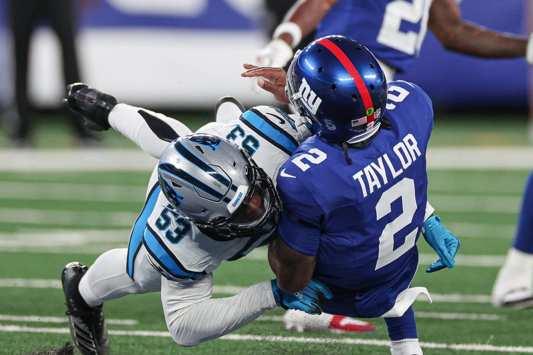 Aug 18, 2023; East Rutherford, New Jersey, USA; New York Giants quarterback Tyrod Taylor (2) is hit by Carolina Panthers linebacker Deion Jones (53) after throwing a touchdown pass during the first half at MetLife Stadium. Mandatory Credit: Vincent Carchietta-USA TODAY Sports