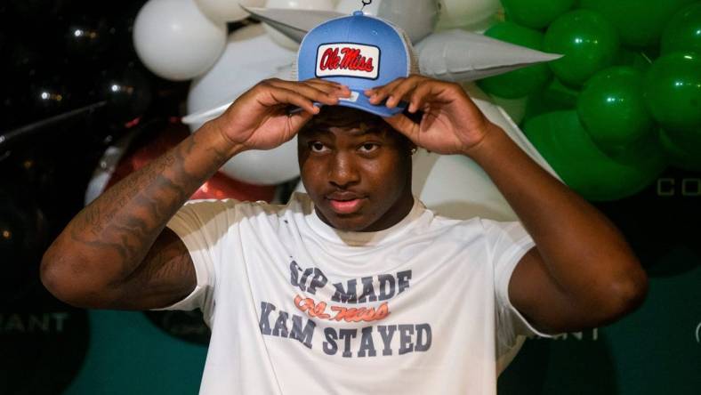 Kamarion Franklin, the No. 1 recruit in Mississippi, puts on an Ole Miss hat as he announces his commitment to Ole Miss football while wearing a shirt that says       Sip Made Kam Stayed    with the Ole Miss logo at Lake Cormorant High School in Lake Cormorant, Miss, on Saturday, August 19, 2023.