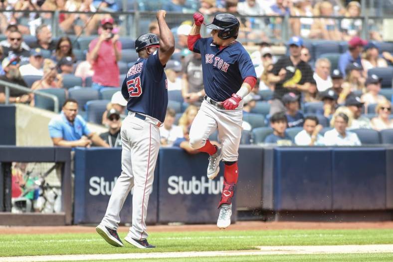 Aug 19, 2023; Bronx, New York, USA;  Boston Red Sox second baseman Luis Urias (17) celebrates with third base coach Carlos Febles after hitting. A home run in the second inning against the New York Yankees at Yankee Stadium. Mandatory Credit: Wendell Cruz-USA TODAY Sports