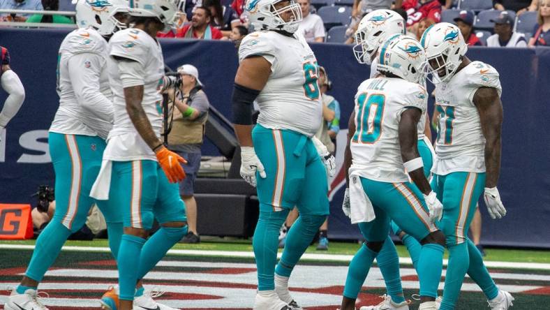 Aug 19, 2023; Houston, Texas, USA; Miami Dolphins wide receiver Tyreek Hill (10) celebrates running back Raheem Mostert (31) touchdown against the Houston Texans in the first quarter at NRG Stadium. Mandatory Credit: Thomas Shea-USA TODAY Sports