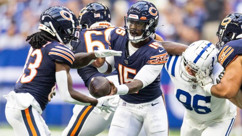 Aug 19, 2023; Indianapolis, Indiana, USA; Chicago Bears quarterback PJ Walker (15) hands off the ball to  wide receiver Nsimba Webster (83) in the first quarter against the Indianapolis Colts at Lucas Oil Stadium. Mandatory Credit: Trevor Ruszkowski-USA TODAY Sports