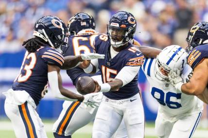 Aug 19, 2023; Indianapolis, Indiana, USA; Chicago Bears quarterback PJ Walker (15) hands off the ball to  wide receiver Nsimba Webster (83) in the first quarter against the Indianapolis Colts at Lucas Oil Stadium. Mandatory Credit: Trevor Ruszkowski-USA TODAY Sports