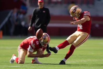 Aug 19, 2023; Santa Clara, California, USA;  San Francisco 49ers place kicker Jake Moody (4) kicks the ball as punter Mitch Wishnowsky (18) holds it in place during warmups before the start of the first quarter against the Denver Broncos at Levi's Stadium. Mandatory Credit: Stan Szeto-USA TODAY Sports