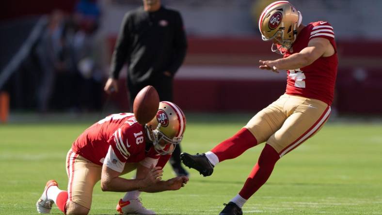 Aug 19, 2023; Santa Clara, California, USA;  San Francisco 49ers place kicker Jake Moody (4) kicks the ball as punter Mitch Wishnowsky (18) holds it in place during warmups before the start of the first quarter against the Denver Broncos at Levi's Stadium. Mandatory Credit: Stan Szeto-USA TODAY Sports