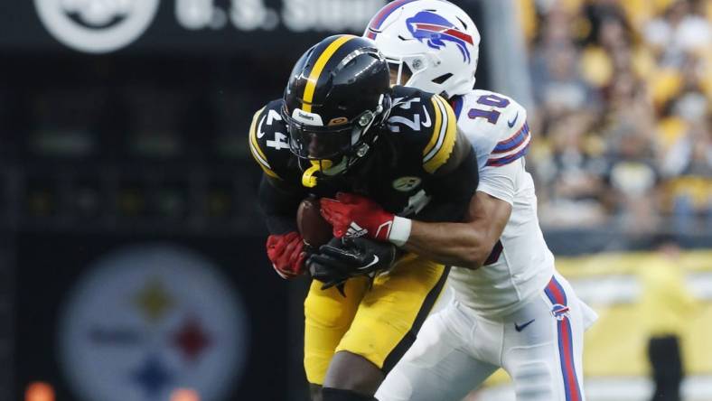 Aug 19, 2023; Pittsburgh, Pennsylvania, USA; Pittsburgh Steelers cornerback Joey Porter Jr. (24) is tackled after intercepting a pass intended for Buffalo Bills wide receiver Khalil Shakir (10) during the second quarter at Acrisure Stadium. Mandatory Credit: Charles LeClaire-USA TODAY Sports