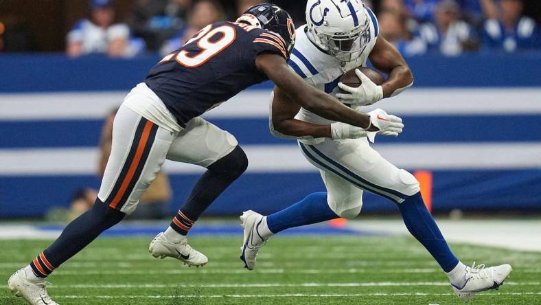 Chicago Bears cornerback Tyrique Stevenson (29) drives Indianapolis Colts running back Kenyan Drake (31) out of bounds with a tackle during the first half of an NFL preseason game Saturday, Aug. 19, 2023, at Lucas Oil Stadium in Indianapolis.