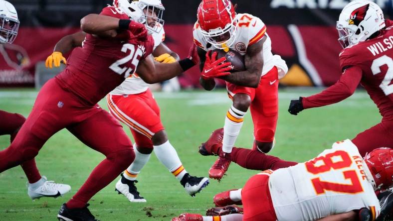 Aug 19, 2023; Glendale, AZ, USA; Kansas City Chiefs wide receiver Richie James (17) carries the ball against Arizona Cardinals linebacker Zaven Collins (25) in the first half of a preseason game at State Farm Stadium. Mandatory Credit: Rob Schumacher-Arizona Republic