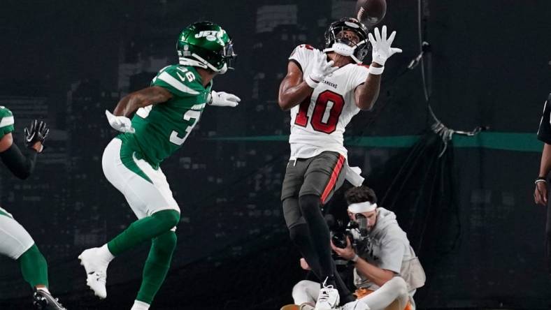 Tampa Bay Buccaneers wide receiver Trey Palmer (10) catches a touchdown pass as New York Jets cornerback Derrick Langford (36) looks on in the first half of a preseason NFL game at MetLife Stadium on Saturday, Aug. 19, 2023, in East Rutherford.