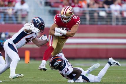 Aug 19, 2023; Santa Clara, California, USA;  San Francisco 49ers tight end Charlie Woerner (89) attempts to leap over Denver Broncos safety Kareem Jackson (22) and linebacker Josey Jewell (47) during the second quarter at Levi's Stadium. Mandatory Credit: Stan Szeto-USA TODAY Sports
