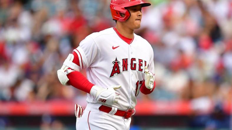 Aug 19, 2023; Anaheim, California, USA; Los Angeles Angels designated hitter Shohei Ohtani (17) returns to the dugout after hitting a pop fly ball during the first inning at Angel Stadium. Mandatory Credit: Gary A. Vasquez-USA TODAY Sports