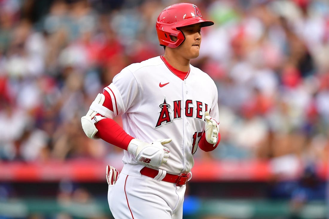 Aug 19, 2023; Anaheim, California, USA; Los Angeles Angels designated hitter Shohei Ohtani (17) returns to the dugout after hitting a pop fly ball during the first inning at Angel Stadium. Mandatory Credit: Gary A. Vasquez-USA TODAY Sports