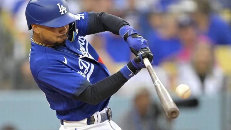 Aug 19, 2023; Los Angeles, California, USA;  Los Angeles Dodgers right fielder Mookie Betts (50) hits a solo home run in the third inning against the Miami Marlins at Dodger Stadium. Mandatory Credit: Jayne Kamin-Oncea-USA TODAY Sports