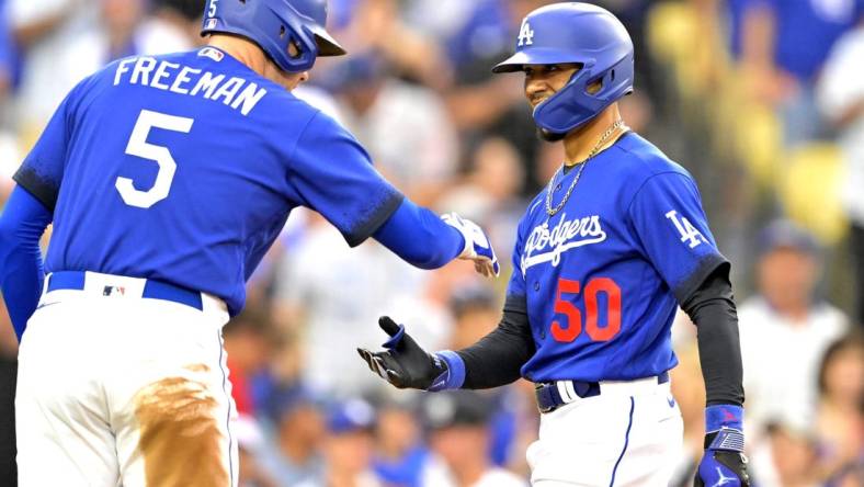 Aug 19, 2023; Los Angeles, California, USA; Los Angeles Dodgers right fielder Mookie Betts (50) is congratulated by first baseman Freddie Freeman (5) after hitting a solo home run in the third inning against the Miami Marlins at Dodger Stadium. Mandatory Credit: Jayne Kamin-Oncea-USA TODAY Sports