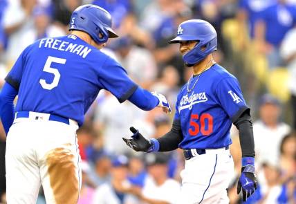Aug 19, 2023; Los Angeles, California, USA; Los Angeles Dodgers right fielder Mookie Betts (50) is congratulated by first baseman Freddie Freeman (5) after hitting a solo home run in the third inning against the Miami Marlins at Dodger Stadium. Mandatory Credit: Jayne Kamin-Oncea-USA TODAY Sports