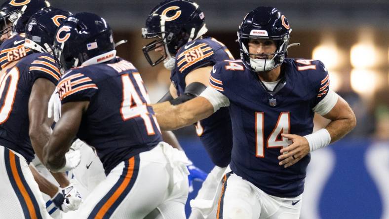 Aug 19, 2023; Indianapolis, Indiana, USA; Chicago Bears quarterback Nathan Peterman (14) hands off the ball to Chicago Bears fullback Robert Burns (45) in the second half against the Indianapolis Colts at Lucas Oil Stadium. Mandatory Credit: Trevor Ruszkowski-USA TODAY Sports