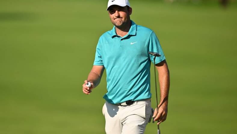 Aug 20, 2023; Olympia Fields, Illinois, USA; Scottie Scheffler walks off the 18th green after finishing the final round of the BMW Championship golf tournament. Mandatory Credit: Jamie Sabau-USA TODAY Sports