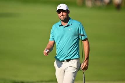Aug 20, 2023; Olympia Fields, Illinois, USA; Scottie Scheffler walks off the 18th green after finishing the final round of the BMW Championship golf tournament. Mandatory Credit: Jamie Sabau-USA TODAY Sports