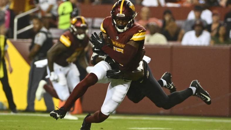 Aug 21, 2023; Landover, Maryland, USA; Washington Commanders wide receiver Terry McLaurin (17) runs after a catch during the first half at FedExField. Mandatory Credit: Brad Mills-USA TODAY Sports