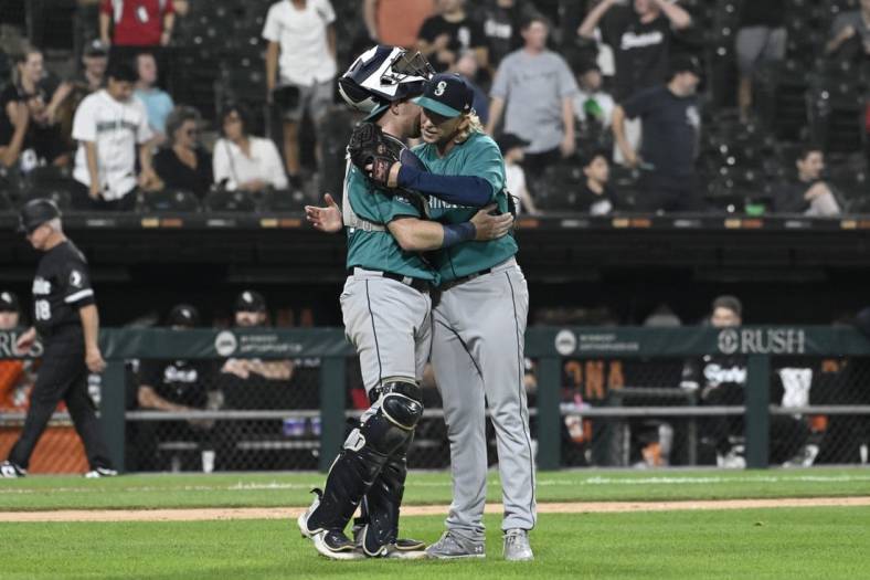 Aug 21, 2023; Chicago, Illinois, USA;  Seattle Mariners catcher Brian O'Keefe (64) and Seattle Mariners relief pitcher Darren McCaughan (26) after the game against the Chicago White Sox at Guaranteed Rate Field. Mandatory Credit: Matt Marton-USA TODAY Sports