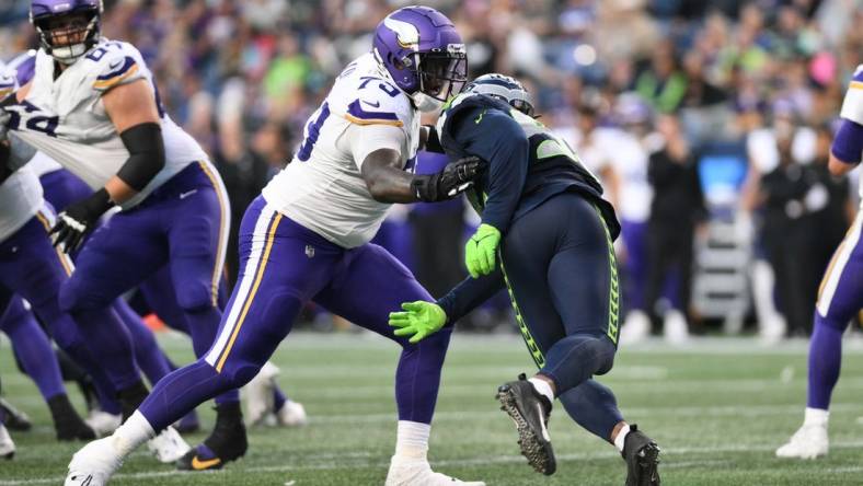 Aug 10, 2023; Seattle, Washington, USA; Minnesota Vikings offensive tackle Vederian Lowe (79) blocks Seattle Seahawks linebacker Tyreke Smith (92) during the game at Lumen Field. Mandatory Credit: Steven Bisig-USA TODAY Sports