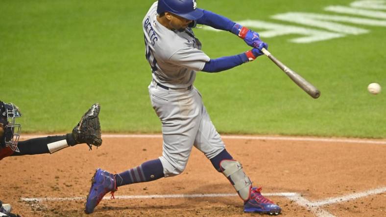 Aug 23, 2023; Cleveland, Ohio, USA; Los Angeles Dodgers right fielder Mookie Betts (50) singles in the second inning against the Cleveland Guardians at Progressive Field. Mandatory Credit: David Richard-USA TODAY Sports