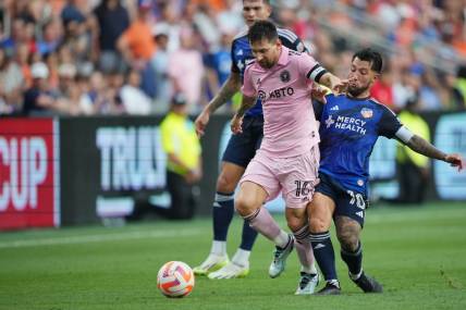 Aug 23, 2023; Cincinnati, OH, USA; Inter Miami forward Lionel Messi (10) plays the ball defended by FC Cincinnati midfielder Luciano Acosta (10) in the first half at TQL Stadium. Mandatory Credit: Aaron Doster-USA TODAY Sports