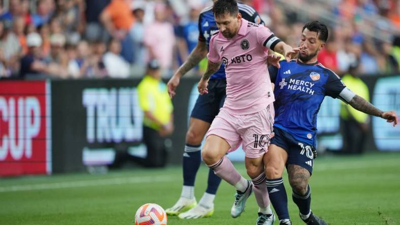 Aug 23, 2023; Cincinnati, OH, USA; Inter Miami forward Lionel Messi (10) plays the ball defended by FC Cincinnati midfielder Luciano Acosta (10) in the first half at TQL Stadium. Mandatory Credit: Aaron Doster-USA TODAY Sports