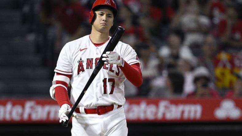 Aug 23, 2023; Anaheim, California, USA; Los Angeles Angels designated hitter Shohei Ohtani (17) looks at his bat during the ninth inning against the Cincinnati Reds at Angel Stadium. Mandatory Credit: Orlando Ramirez-USA TODAY Sports