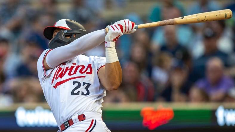 Aug 24, 2023; Minneapolis, Minnesota, USA; Minnesota Twins third baseman Royce Lewis (23) hits a double in the fourth inning against the Texas Rangers in the fourth inning at Target Field. Mandatory Credit: Jesse Johnson-USA TODAY Sports