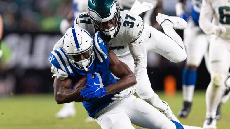 Aug 24, 2023; Philadelphia, Pennsylvania, USA; Philadelphia Eagles cornerback Kelee Ringo (37) tackles Indianapolis Colts wide receiver Breshad Perriman (9) after his catch during the third quarter at Lincoln Financial Field. Mandatory Credit: Bill Streicher-USA TODAY Sports